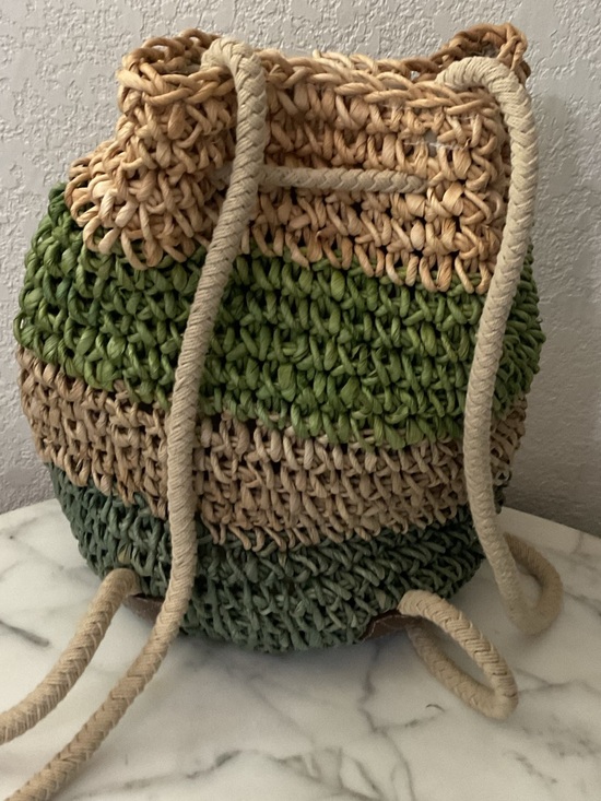 Hand crafted drawstring back pack,artisan style,raffia material,wood leaf charm